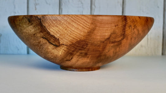 Hand-turned hickory bowl with natural wood grain, 12 inches wide